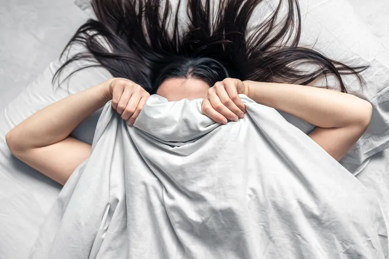 young-woman-sleeps-white-bed