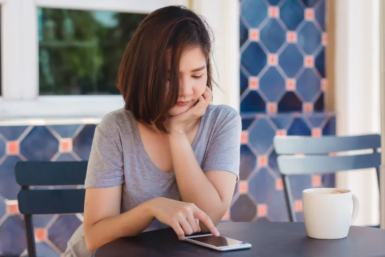 asian-young-woman-sitting-cafe-drinking-coffee-using-smartphone