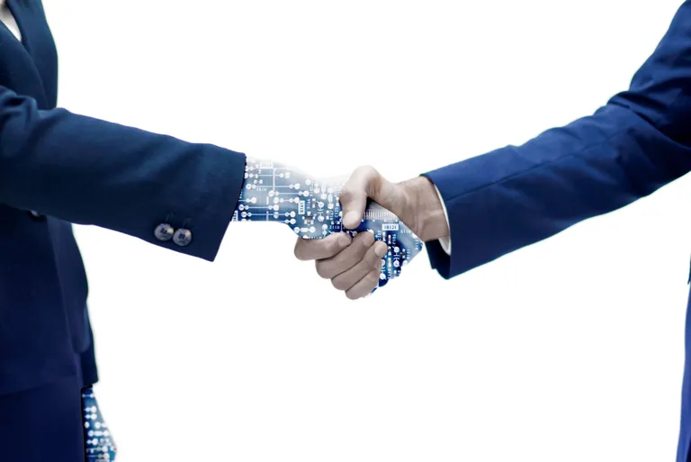 man-shaking-hand-with-robotic-arm