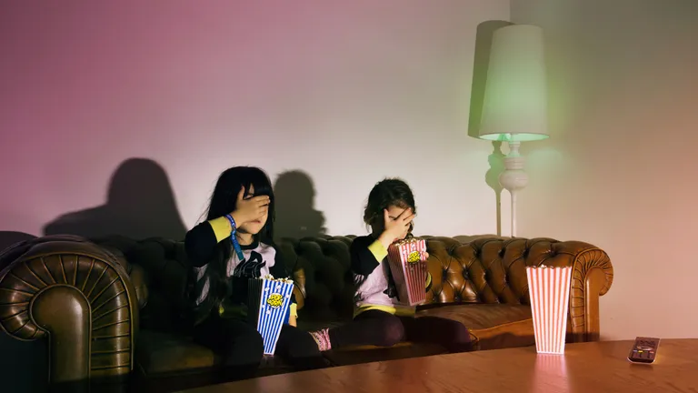 scared-girls-with-popcorn-watching-tv