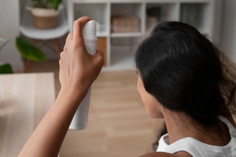 woman-using-dry-shampoo-home