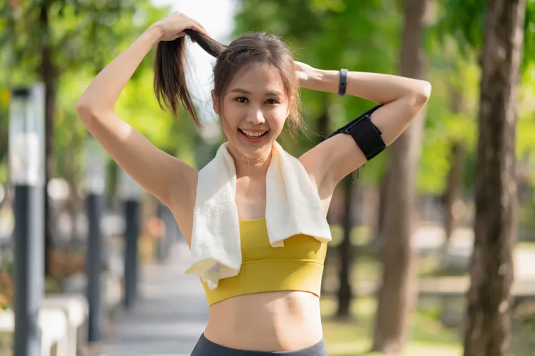 smiling-asian-female-active-sport-lifestyle-warmup-stretching-before-running-exercise-while-arranging-her-hair-park-morning-workout-healthy-lifestyle-well-being-life