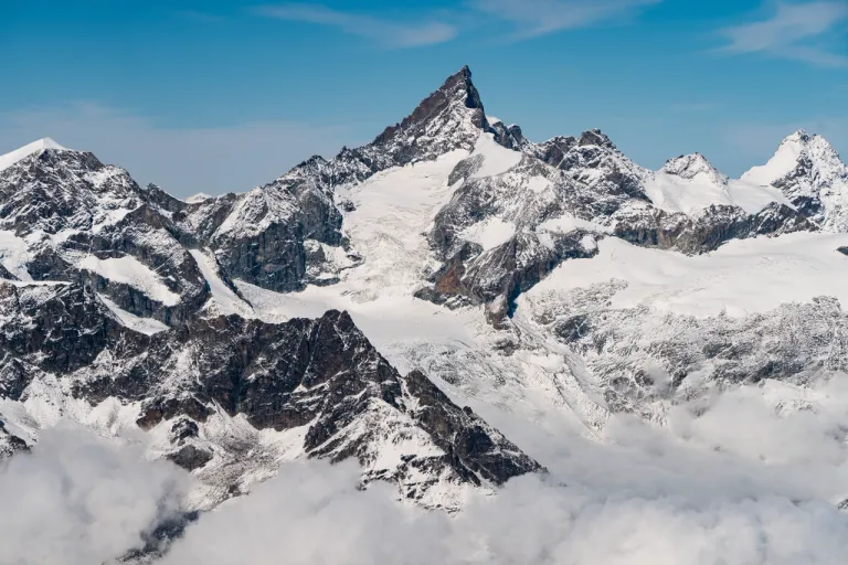 high-rocky-mountains-covered-with-snow-clear-blue-sky-switzerland