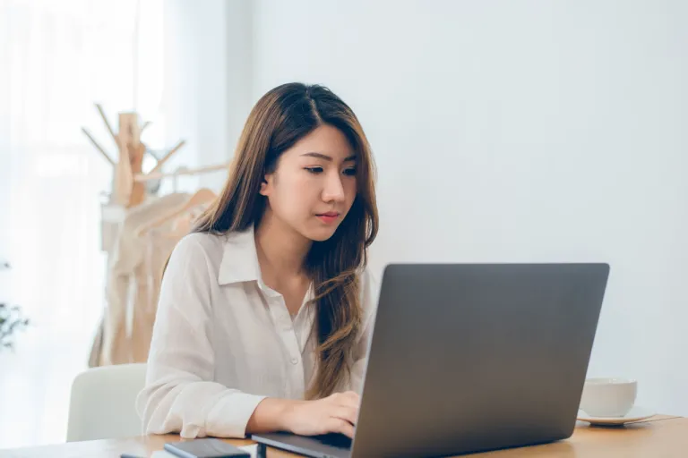 asian-woman-working-laptop-while-home-office-work-space