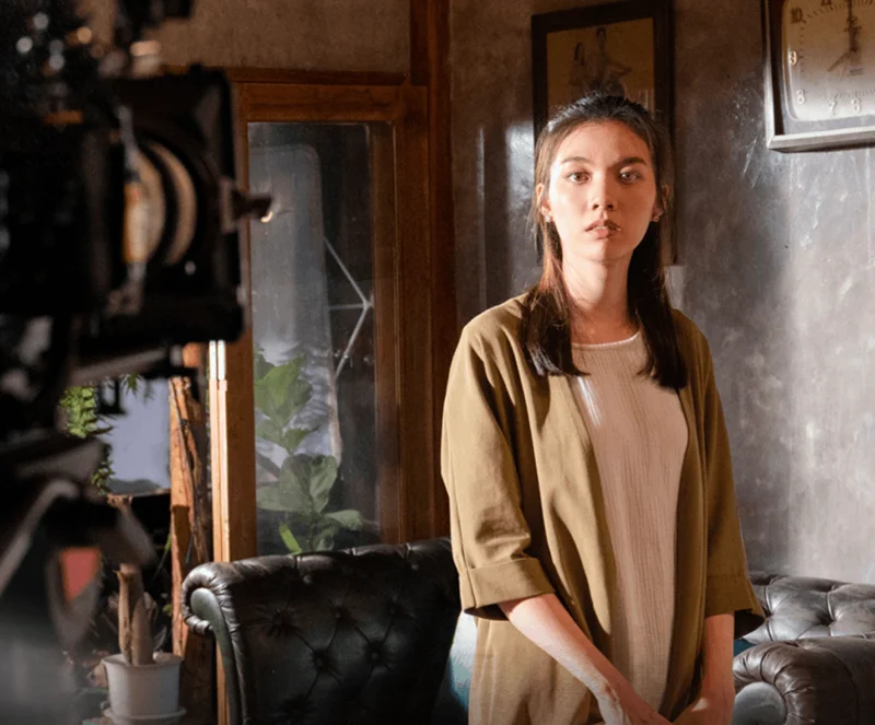 A behind-the-scene photo of Kornnaphat "Aom" Sethratanapong in 2023 Thai PBS 2-part drama 'Nakak (หน้ากาก)'